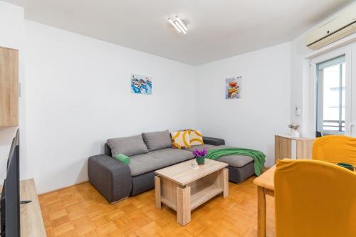 a living room with a couch and a table at Apartment Stellina in Štinjan