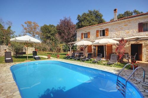 a swimming pool in front of a house at Villa Katherine with Pool and Game Room in Žminj
