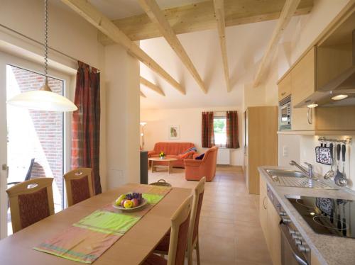 a kitchen and living room with a table and chairs at Bauernhof Sauer - Heuerhus in Varel