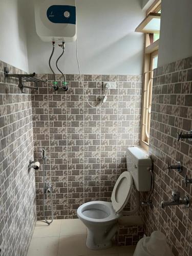 a bathroom with a toilet and a shower at Alpine Guest House in Gangtok