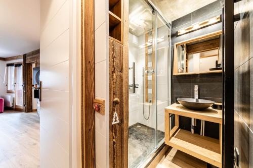 a bathroom with a sink and a glass shower at L Elinka - Immodreams - Avoriaz in Avoriaz