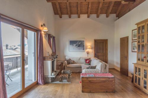 a living room with a couch and a table at Chesa Seja - Zuoz in Zuoz