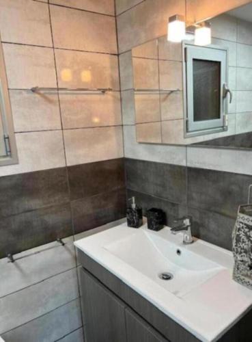 a bathroom with a sink and a mirror at Assossego House - Gerês in Geres