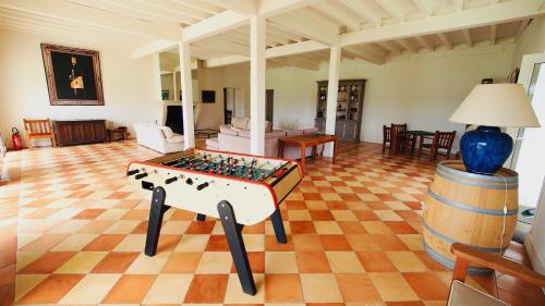 a living room with a foosball table and a barrel at Domaine de Gorre in Martillac