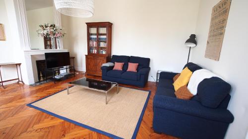 a living room with two couches and a coffee table at Domaine de Gorre in Martillac