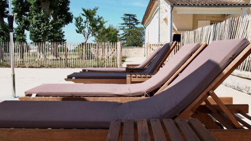 a row of empty lounge chairs on a playground at Domaine de Gorre in Martillac