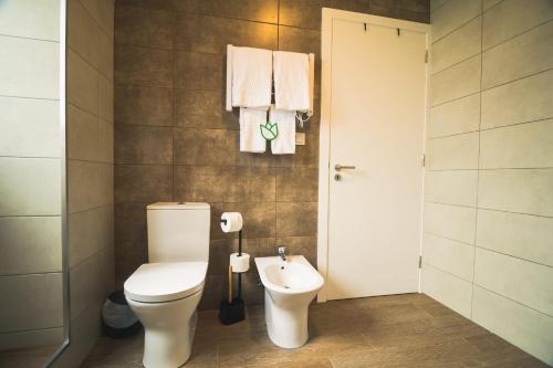a bathroom with a toilet and a sink at Vila Rosario in Ponta Delgada