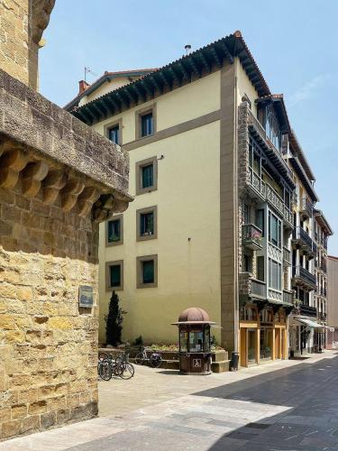 a building with a gazebo next to a street at EARRA - Casa Fabiola, centro y a 2 min de la playa in Zarautz