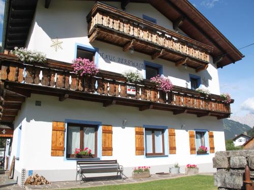 a building with a balcony and flowers on it at Apartment in Bichlbach near Ski Slopes in Bichlbach