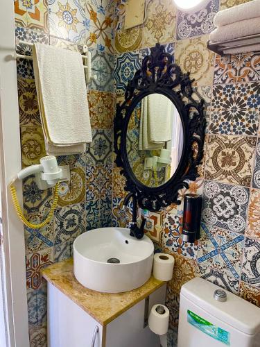 a bathroom with a sink and a mirror at Hotel Barba in Urla
