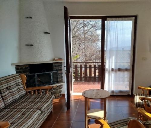 a living room with a couch and a fireplace at Villa Carla - Bosco in Ledro