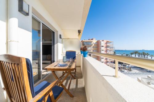 a balcony with a desk and a view of the ocean at Mediterranean Way - Paradis Park Superior in La Pineda