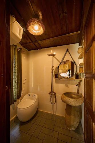a bathroom with a toilet and a sink at Mật Retreat in Ba Vì