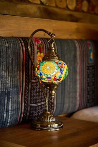 a small lamp on a table next to a couch at Mật Retreat in Ba Vì