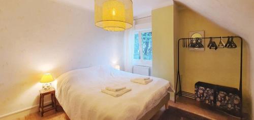 a bedroom with a bed with two towels on it at Maison Ty Plage in Quiberon