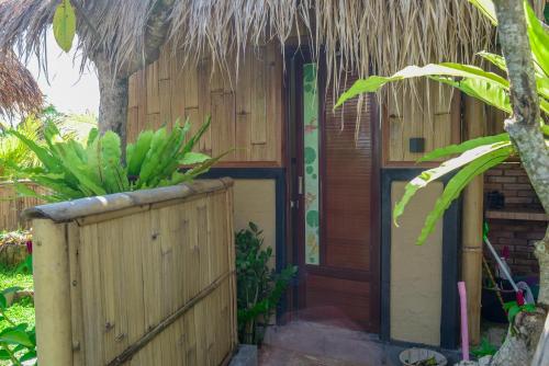a house with a wooden door and a fence at One Bali Villa in Bangli