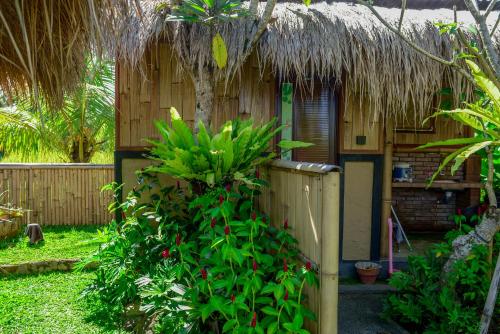 a small house with a thatch roof at One Bali Villa in Bangli
