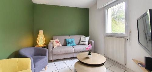 a living room with a couch and a chair at Maison Ty Cloclo in Quiberon