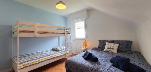 a bedroom with a bunk bed next to a window at Maison Ty Cloclo in Quiberon
