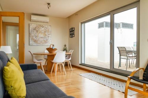 a living room with a couch and a table at Rooftop Terrace Apartment PDL in Ponta Delgada