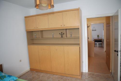 a kitchen with wooden cabinets in a room at Bermuda Apartment in Bochum