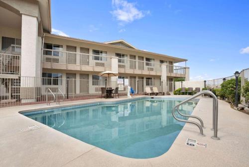 a swimming pool in front of a building at Days Inn by Wyndham Globe in Globe