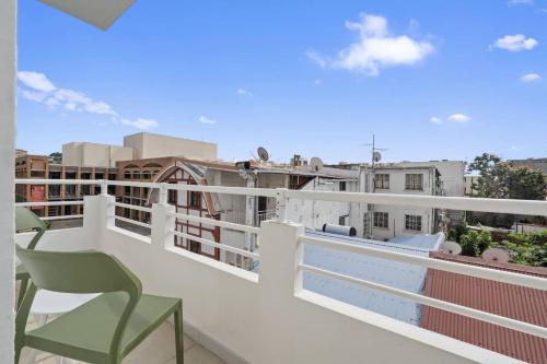 a balcony with chairs and a view of the city at Bohème Chic Immeuble Le Botanik in Fort-de-France