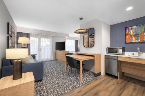 a living room with a couch and a table in a hotel room at Homewood Suites by Hilton San Diego Airport-Liberty Station in San Diego