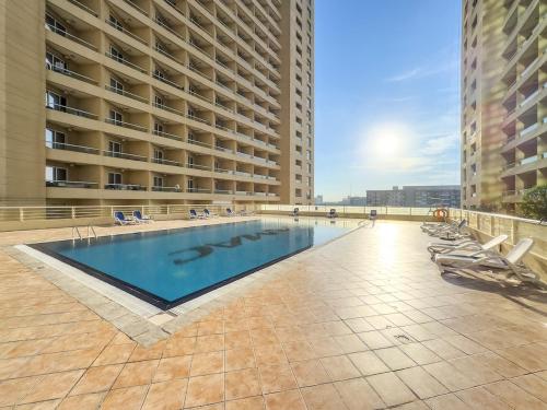 a large swimming pool in the middle of a building at FIRST CLASS Studio Cozy & Chic Retreat in Dubai