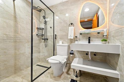 a bathroom with a toilet and a sink and a shower at FIRST CLASS Studio Cozy & Chic Retreat in Dubai