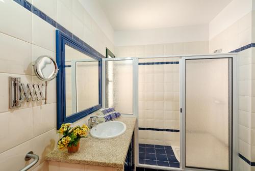 a bathroom with a sink and a shower at Casa Martagão do Gerês by Gerês Casas in Caniçada