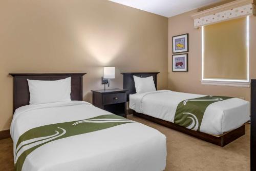 a hotel room with two beds and a window at Quality Inn & Suites Quispamsis in Saint John