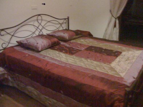 a bed with two pillows on top of it at Amigo 2 in Cap Skirring