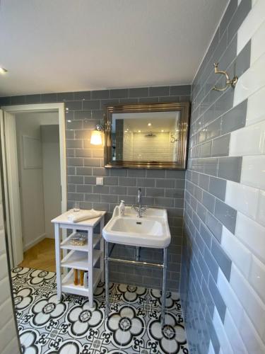 a bathroom with a sink and a mirror at Pension Gablenz in Chemnitz