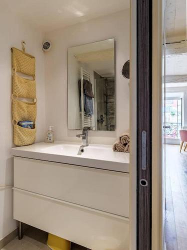 une salle de bain avec un lavabo et un miroir dans l'établissement Joli loft entre le vieux Nice et le port, à Nice