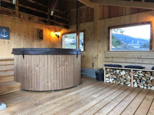 an inside view of a wooden cabin with a large wooden bar at Gurkhof Ferienwohnungen in Gnesau