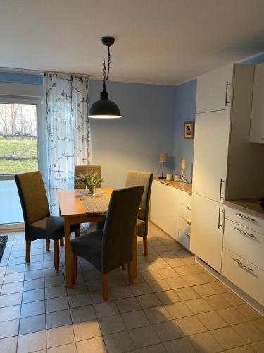 a kitchen and dining room with a table and chairs at Seestraße 70, Ap 30 in Zingst