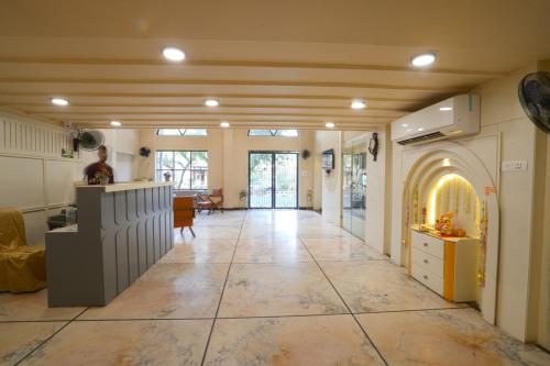 a large living room with a large tile floor at Hotel Square 36 in Kota