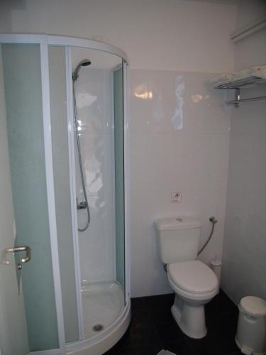 a bathroom with a toilet and a glass shower at Panorama Paros in Parikia