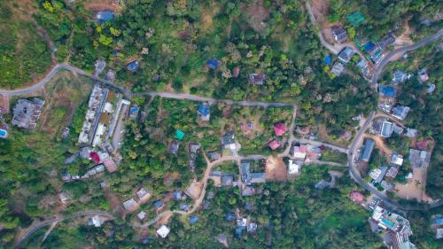 an overhead view of a yard with houses and trees at The Cozy Winterfell in Munnar