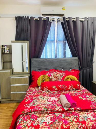 a bedroom with a large red bed with red pillows at EM Suite Home 2Bedroom Dperdana Apartment in Kota Bharu