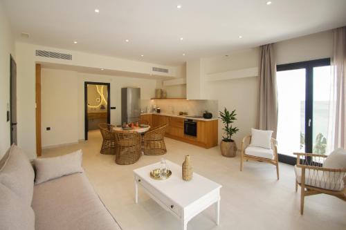 a living room with a couch and a table at Pnoe Villas Syros in Megas Yialos-Nites