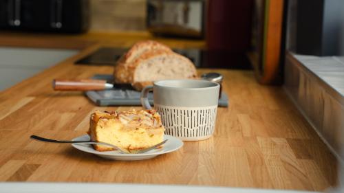 a piece of bread and a cup of coffee on a table at Bridge View Cottage in Cawood