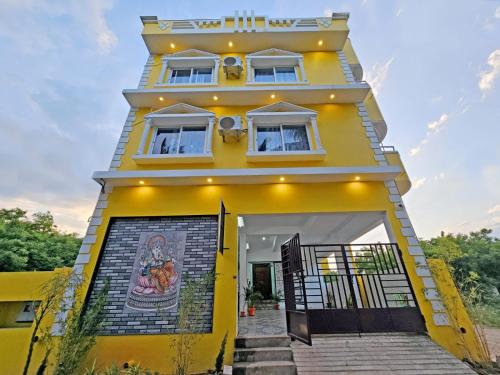 a yellow house with a painting on the side of it at Seaside Escape Villa With Swimming Pool in Puducherry
