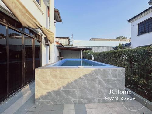 a swimming pool in the backyard of a house at Kempas Bungalow with KTV SwimmingPool in Johor Bahru