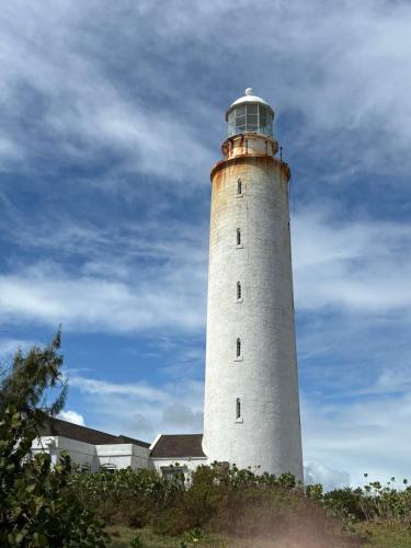 a lighthouse sitting on top of a hill at T.Cole’s Holiday Rental in Saint James