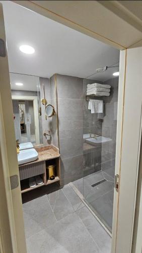 a bathroom with a shower and a sink at Roccia DownTown Otel in Van