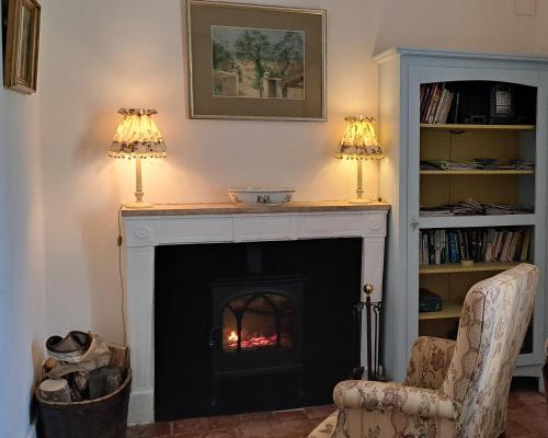 - un salon avec une cheminée et 2 lampes dans l'établissement Etape du Pont Pinard, à Semur-en-Auxois