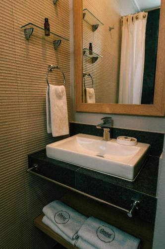 a bathroom with a sink and a mirror and towels at Canada Central & Rooftop in Mexico City