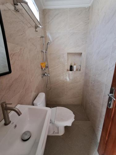 a bathroom with a toilet and a sink and a shower at Teras Kaca in Bibis
